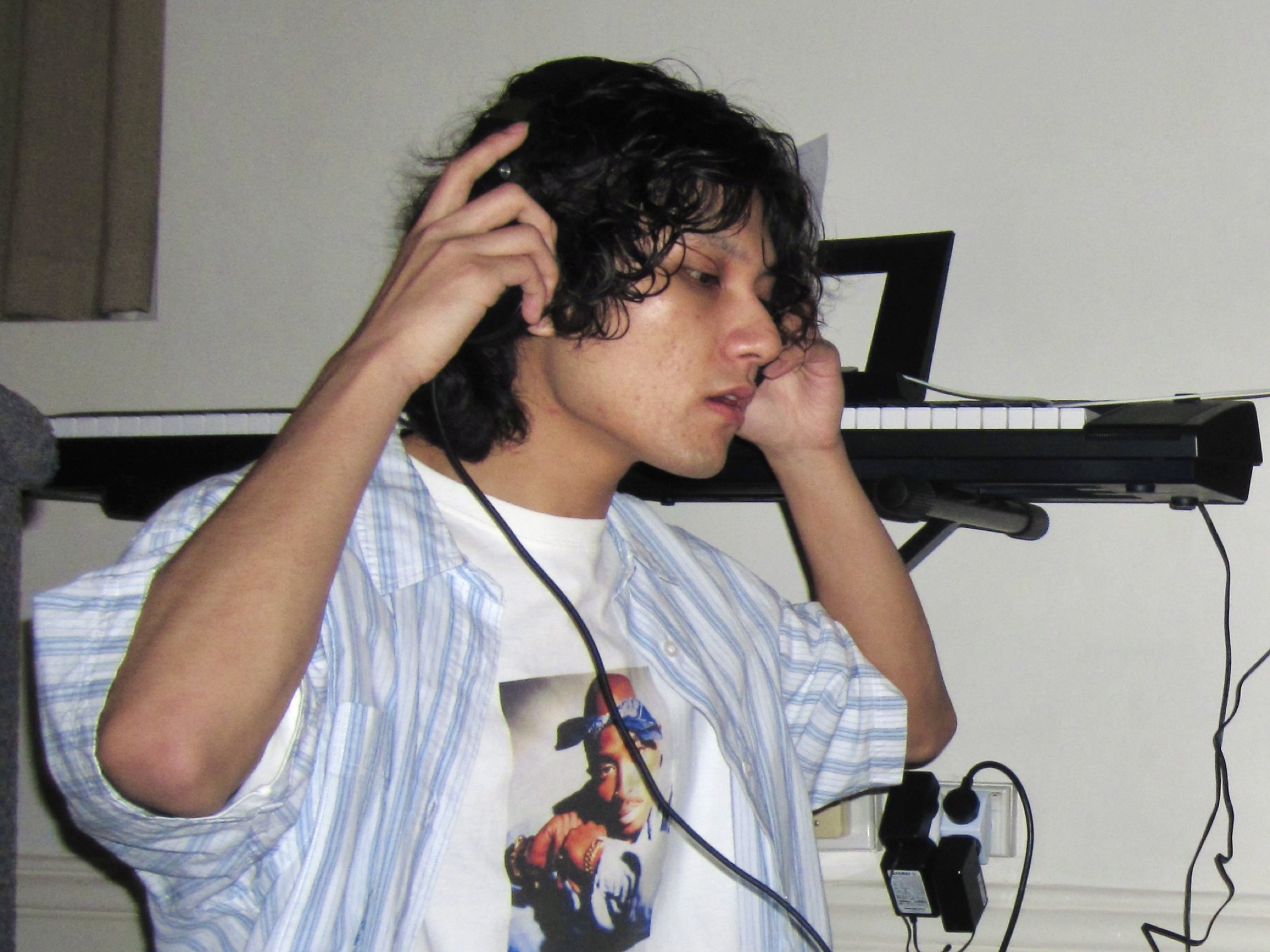 KUMA adjusting headphones in the studio.